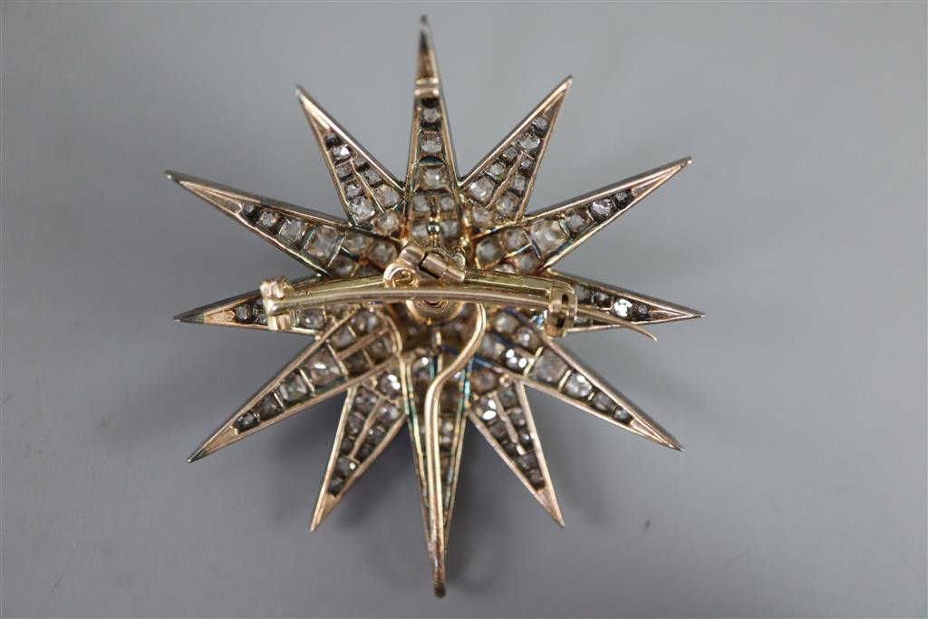 A Victorian gold, silver and graduated old round and cushion cut diamond set starburst pendant brooch,